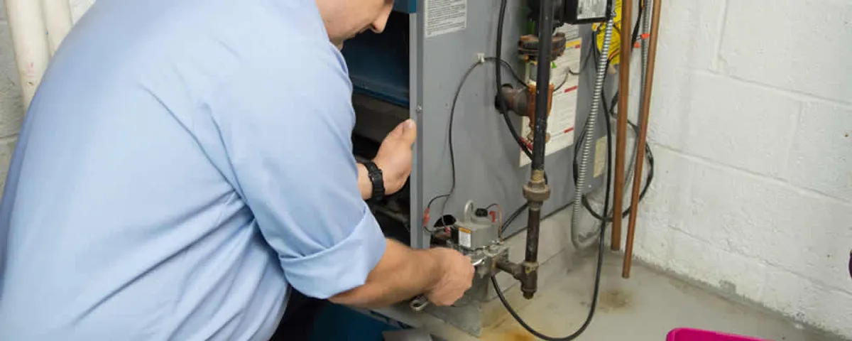 Furnace repair technician inspecting and servicing a home heating system in Chandler, AZ
