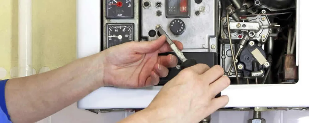 Heating repair technician adjusting boiler controls and components in Chandler, AZ