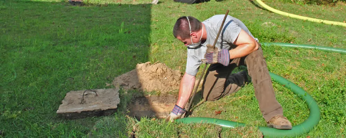 Septic pumping technician servicing a residential septic tank in Chandler, AZ